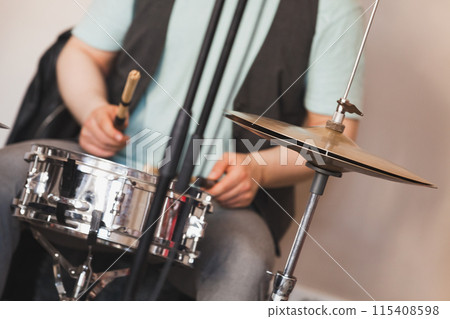 Drummer plays snare drum and cymbals, close-up photo 115408598