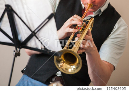 Trumpet player. A brass instrument commonly used in classical and jazz music 115408605