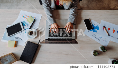 Top shot of Modern Workspace with Computer, Laptop, and Plant on Table: A Practical and Efficient Setup for White-Collar Workers Top shot of Modern Workspace with Computer, Laptop, and Plant on Table: A Practical and Efficient Setup for White-Collar Workers 115408773