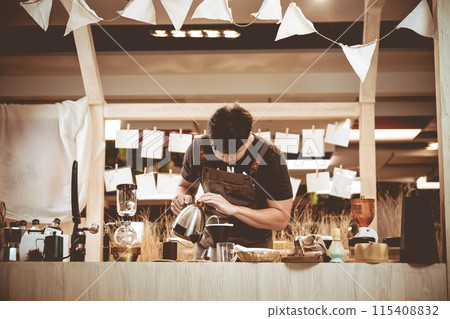 Professional coffee maker - Barista using coffee siphon brewing hot espresso at coffee shop coffee brewing syphon alternative method. Startup Business Concept. Professional coffee maker - Barista using coffee siphon brewing hot espresso at coffee shop coffee brewing syphon alternative method. Startup Business Concept. 115408832