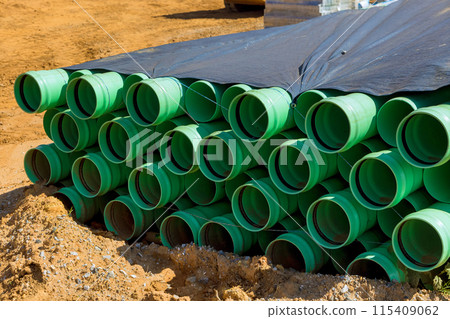 There are green PVC pipes installed on construction sites for installing water supply system for new residence 115409062