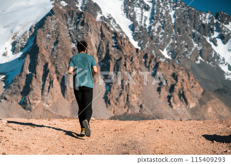 Man is running, jogging in the mountains. 115409293
