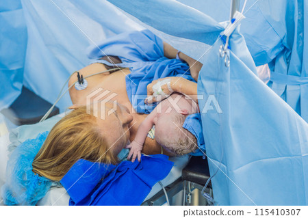 Baby on mother's chest immediately after birth in a hospital. The mother and newborn share a tender moment, emphasizing the bond and emotional connection. The medical staff ensures a safe and caring Baby on mother's chest immediately after birth in a hospital. The mother and newborn share a tender moment, emphasizing the bond and emotional connection. The medical staff ensures a safe and caring 115410307