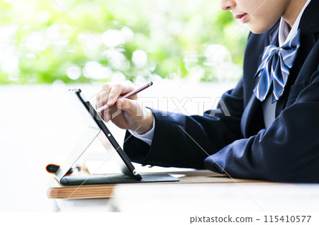 Junior high school student studying on a tablet Junior high school student studying on a tablet 115410577