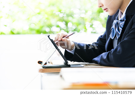 Junior high school student studying on a tablet Junior high school student studying on a tablet 115410579
