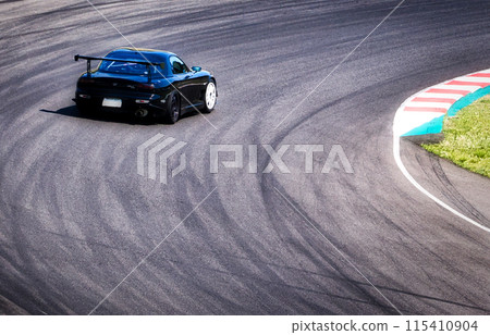 Sports car running on a circuit course 115410904