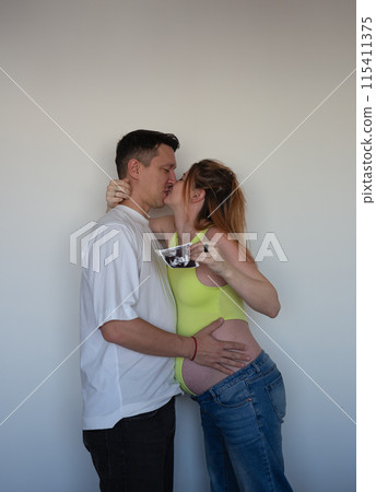 Expecting parents eagerly await their baby's arrival, holding the first ultrasound Expecting parents eagerly await their baby's arrival, holding the first ultrasound 115411375