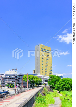Scenery around Kumamoto Station on a beautiful, clear blue sky (East Exit Station, Transportation) [Scenery around the Shirakawa River] 115411550