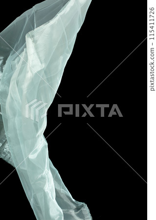 Off White Organza fabric flying in curve shape, Piece of textile White Organza fabric throw fall in air. Black background isolated motion blur Off White Organza fabric flying in curve shape, Piece of textile White Organza fabric throw fall in air. Black background isolated motion blur 115411726