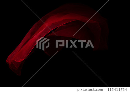 Red organza fabric flying in curve shape, Piece of textile Red organza fabric throw fall in air. Black background isolated, dark shading environment Red organza fabric flying in curve shape, Piece of textile Red organza fabric throw fall in air. Black background isolated, dark shading environment 115411734
