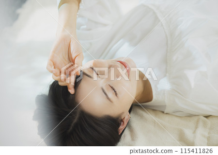 Woman lying on bed Woman lying on bed 115411826