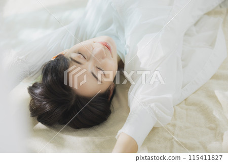 Woman lying on bed Woman lying on bed 115411827