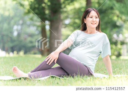 Young Asian woman doing maternity yoga, premama yoga, pilates and stretching in the forest and park 115412557