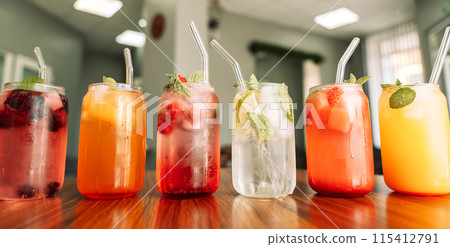 Fruit drinks with berries and ice in glass glasses and straws on a wooden table Fruit drinks with berries and ice in glass glasses and straws on a wooden table 115412791
