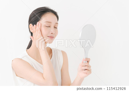 Pretty woman looking in the mirror Pretty woman looking in the mirror 115412926