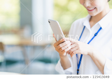 A female employee operating a smartphone. (Parts) A female employee operating a smartphone. (Parts) 115413049
