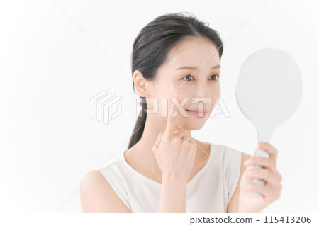 Pretty woman looking in the mirror 115413206