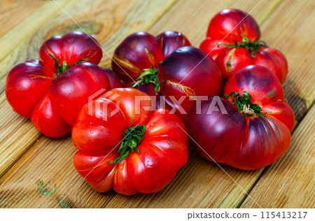 Fresh organic Heirloom tomatoes on wooden table 115413217