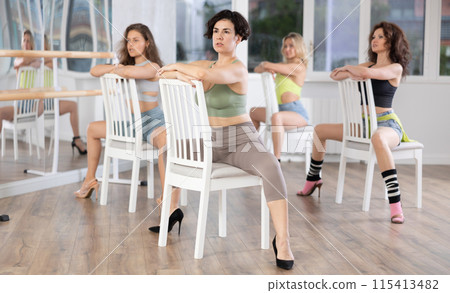 Sitting on chair, woman with haircut train to perform lap dance, interacting with imaginary partner Sitting on chair, woman with haircut train to perform lap dance, interacting with imaginary partner 115413482