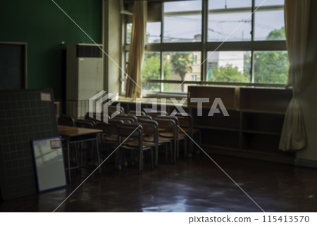 Image of an empty classroom after school with desks pushed into the corner 115413570
