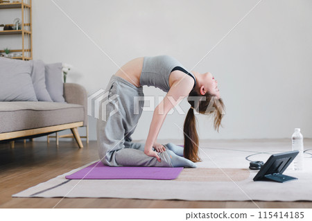 Asian young woman doing yoga stretching exercise on mat yoga, fitness exercises. Healthy lifestyle Calmness and relax at home. Asian young woman doing yoga stretching exercise on mat yoga, fitness exercises. Healthy lifestyle Calmness and relax at home. 115414185