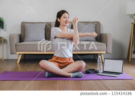 Asian young woman doing yoga stretching exercise on mat yoga, fitness exercises. Healthy lifestyle Calmness and relax at home. Asian young woman doing yoga stretching exercise on mat yoga, fitness exercises. Healthy lifestyle Calmness and relax at home. 115414186