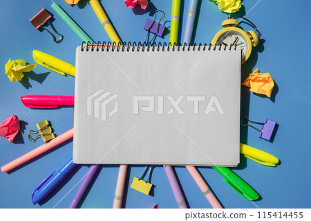 Frame border made of empty white paper notebook school stationery supplies and alarm clock. Copy space for your text or Educational greeting announcement for students and teacher. Creative vivid 115414455