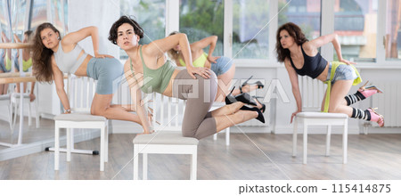 Woman practicing modern stiletto choreography with chair during group class 115414875