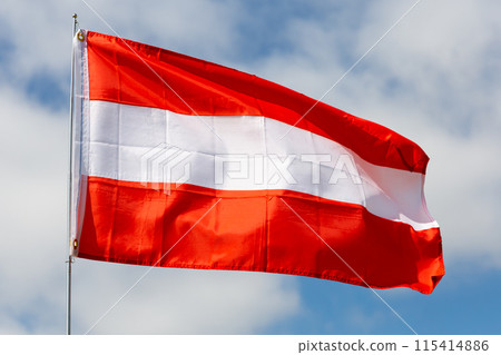Flag of Austria waving on cloudy sky during daytime 115414886