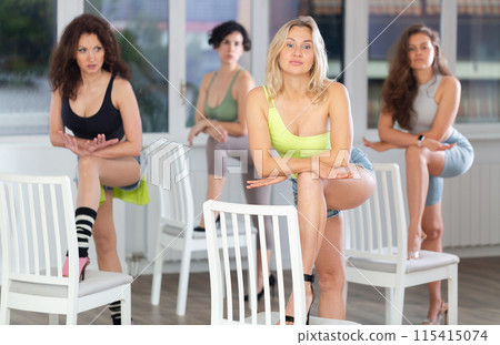 Group of women is dancing strip with chair in dance studio Group of women is dancing strip with chair in dance studio 115415074