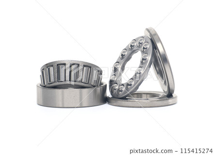 Tapered roller and thrust ball bearings isolated on white Tapered roller and thrust ball bearings isolated on white 115415274