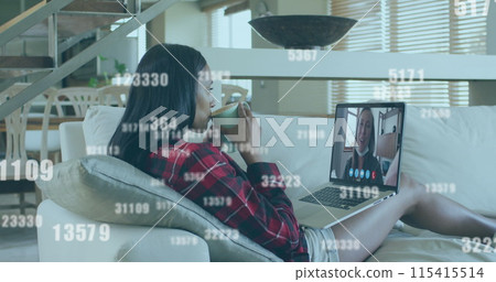 Multiple increasing numbers falling against woman having a image call on laptop at home Multiple increasing numbers falling against woman having a image call on laptop at home 115415514