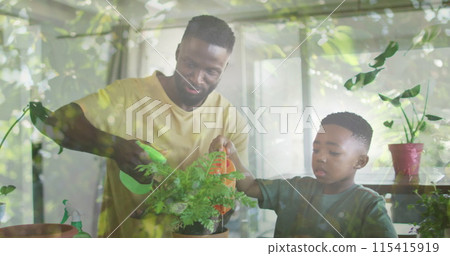 Image of leaves over happy african american father and son watering plant at home Image of leaves over happy african american father and son watering plant at home 115415919