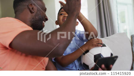 Image of confetti falling over happy african american father and son clapping hands Image of confetti falling over happy african american father and son clapping hands 115415920