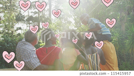 Image of hearts over happy african american multi generation family in garden 115415957