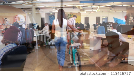 Image of hands using laptop, over colleagues at creative office with bike and on hoverboard Image of hands using laptop, over colleagues at creative office with bike and on hoverboard 115416737