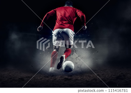 Football player runs ball back action. A football player in action, running with the ball, in a smoky and dark environment, conveying a sense of epic action and wearing a red uniform 115416781