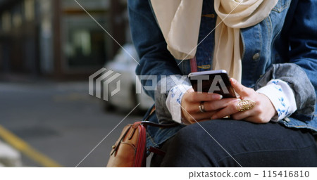 Image of smiling asian woman in hijab with smartphone over cityscape Image of smiling asian woman in hijab with smartphone over cityscape 115416810