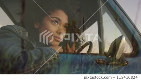 Image of happy african american woman relaxing in car over grass Image of happy african american woman relaxing in car over grass 115416824