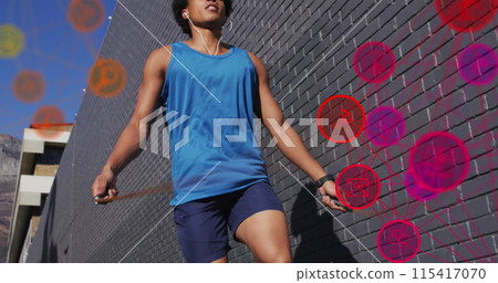 Image of media icons over african american man jumping rope Image of media icons over african american man jumping rope 115417070