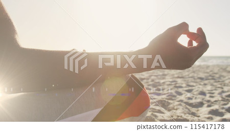 Image of lights over a meditating african american man 115417178