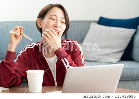 A woman eating cup ramen A woman eating cup ramen 115419696