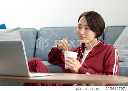 A woman eating cup ramen 115419707