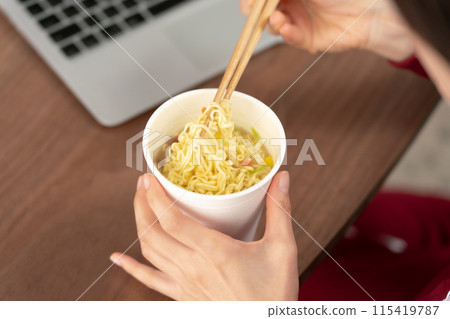 Woman eating cup ramen Woman eating cup ramen 115419787