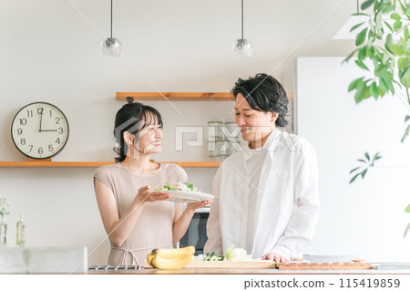 Couple, couple, man and woman, housewife, wife having salad in the kitchen Couple, couple, man and woman, housewife, wife having salad in the kitchen 115419859