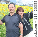 A loving couple in a sunflower field 115420355