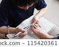 A woman removing her nails 115420361
