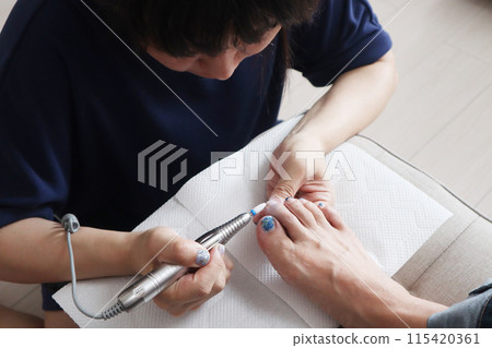 A woman removing her nails 115420361