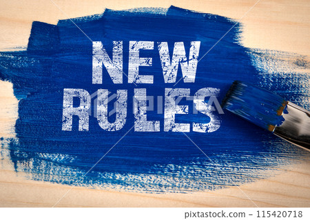 NEW RULES. Blue paint and paint brush on wooden texture background 115420718