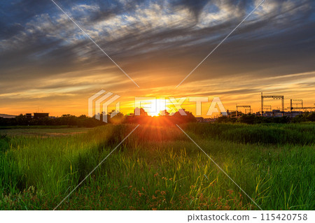 Evening view of the Suzakumon Square at the Heijo-kyo site in Nara: Western sky, the gradation of the sun and clouds bringing the last golden light of the day ⑦ 115420758